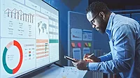 A Man Reviews the Data Analysis of Marketing from Social Media Platforms.