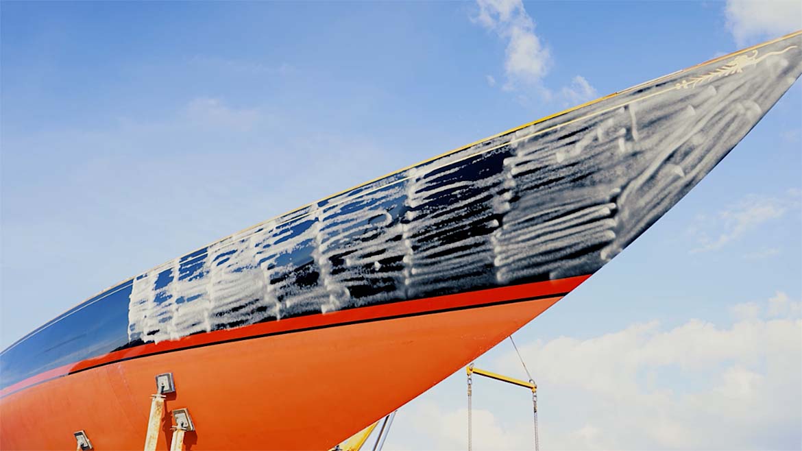 Upward view of the hull of the boat with a cloudy blue sky in the background. The hull is matted and ready for scanning.