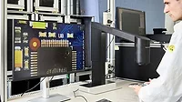 Technician using a digital microscope.