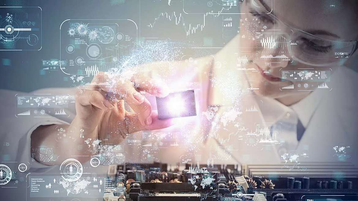 Femail engineer in a lab coat and safety glasses, placing part onto an electronic board. There is a transparent overlay of virtual screens over the entire image.