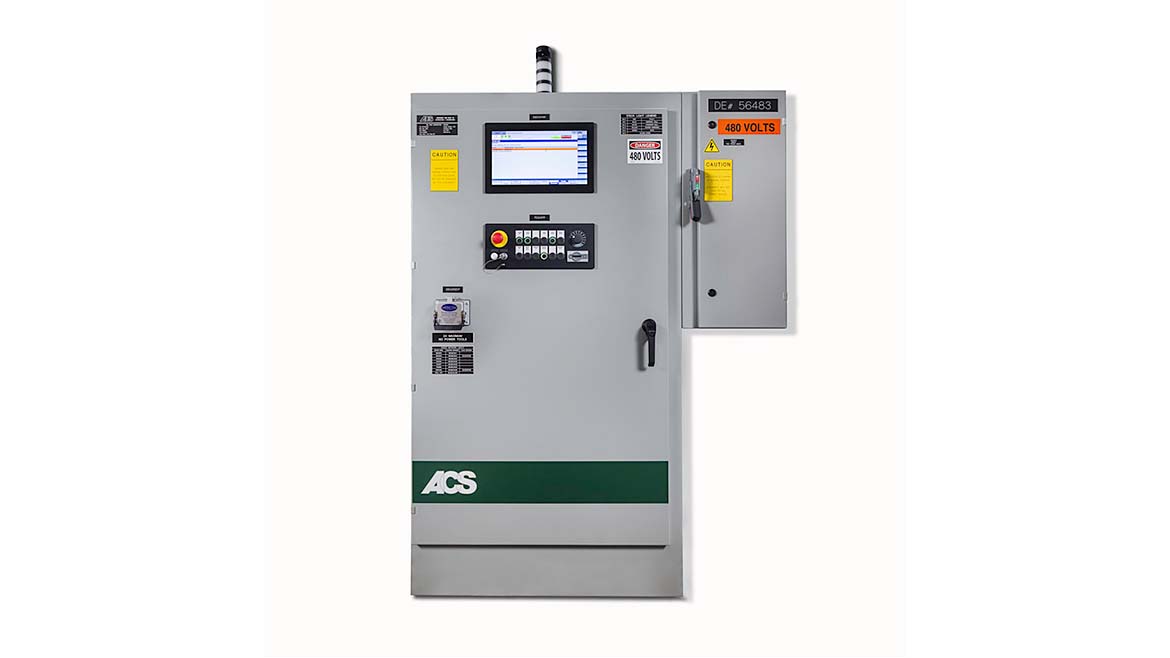 Industrial control panel by ACS with digital display, emergency stop button, key switch, and caution labels indicating 480 volts electrical hazard