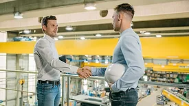 two industrial workers shaking hands