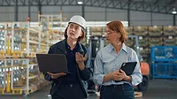 a stock photo of a young Caucasian female worker and a mature female manager in a retail warehouse. a stock photo of a young Caucasian female worker and a mature female manager in a retail warehouse.