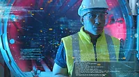 Computer engineer working in factory Computer engineer working in factory with laptop computer GUI graphic user interface technology futuristic sci fi HUD background.