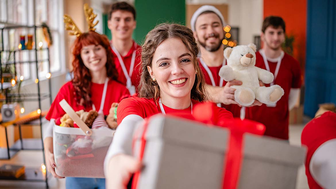 people holding christmas presents