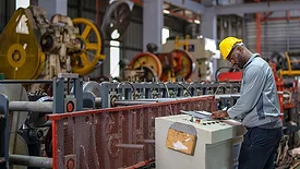 an industrial worker operating machinery in a factory setting