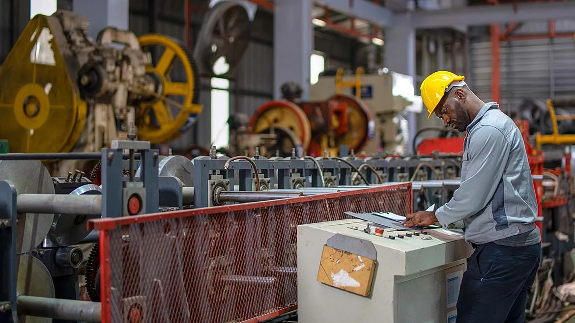 an industrial worker operating machinery in a factory setting