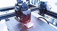 a 3D printer in operation, an additive manufacturing process that builds three-dimensional objects layer by layer from a digital file. a 3D printer in operation, an additive manufacturing process that builds three-dimensional objects layer by layer from a digital file.