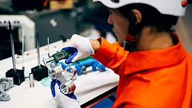 a factory worker assembling electronic components