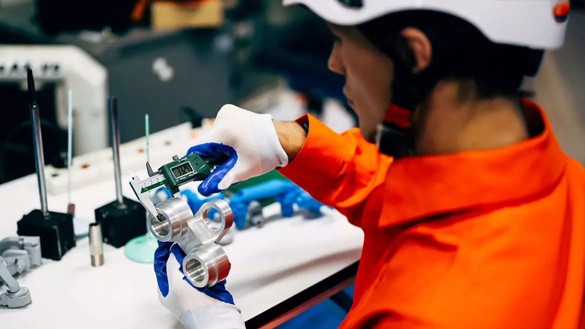 a factory worker assembling electronic components