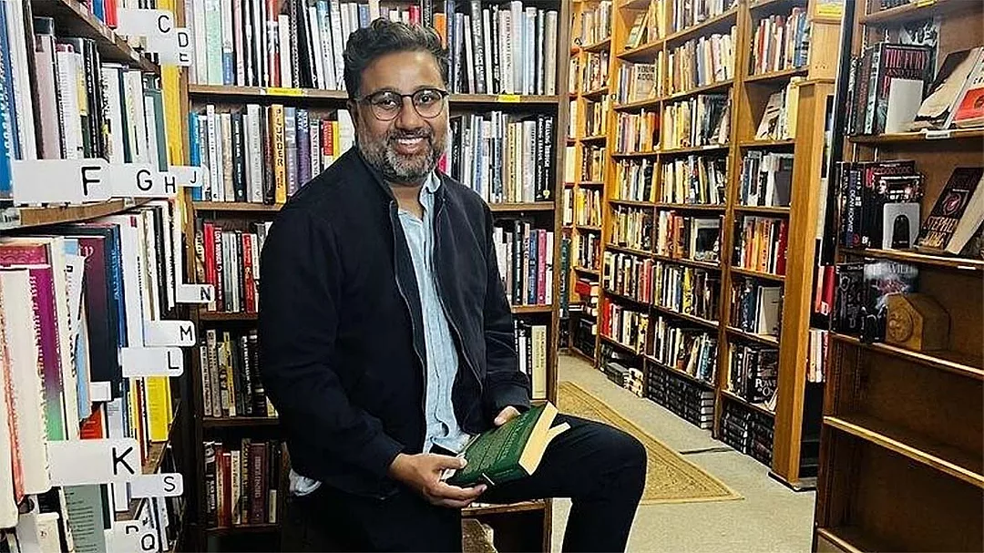 a man, potentially an author, in a bookstore setting