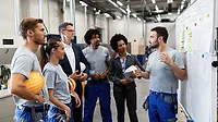  a group of manufacturing workers and management personnel 