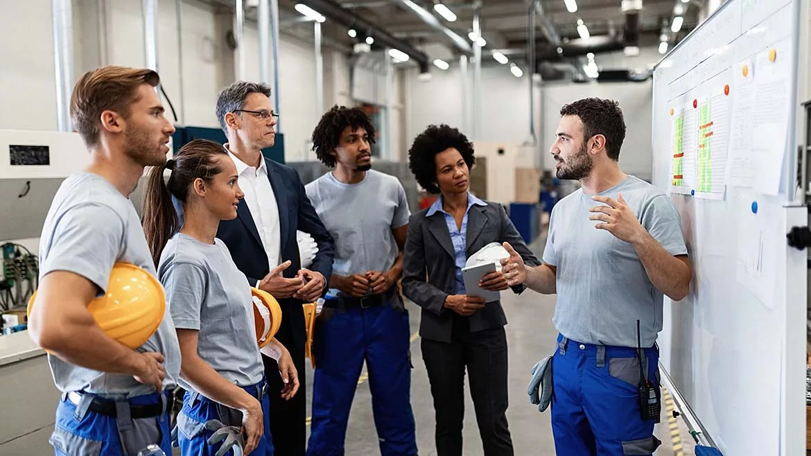  a group of manufacturing workers and management personnel 