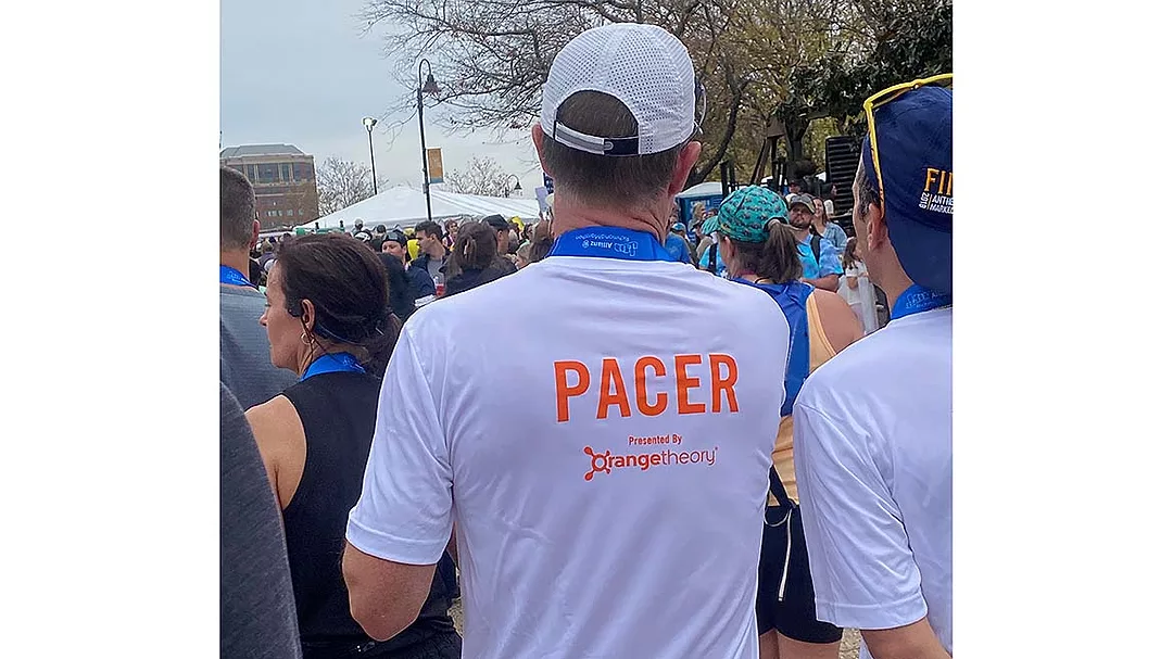 a person participating in a race as a pacer, a runner who helps others maintain a specific speed to achieve their time goals