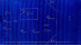 The image displays a blueprint or technical drawing featuring various alphanumeric codes and symbols