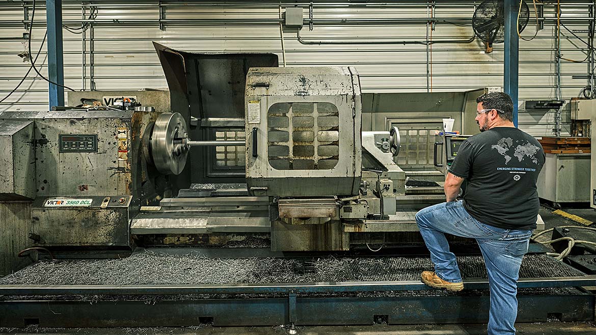 The image shows a large Computer Numerical Control (CNC) lathe machine