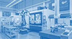 This image depicts a modern industrial manufacturing facility utilizing robotic automation and CNC machinery.