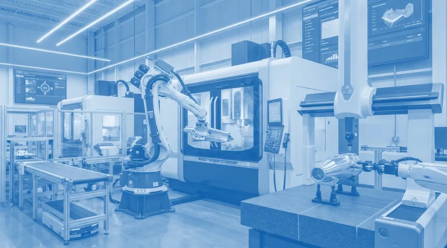 This image depicts a modern industrial manufacturing facility utilizing robotic automation and CNC machinery.