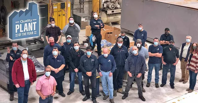 This image captures a moment of recognition for employees at the Phoenix Tube Company, celebrating their "Quality Plant of the Year" award