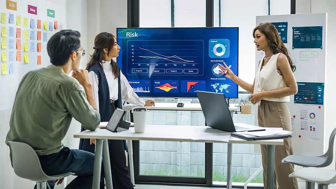 This image depicts a business strategy meeting focused on risk management and data analysis.