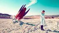 This image depicts a conceptual scene of a scientist or engineer distraught over a failed rocket launch
