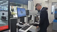The image shows a coordinate measuring machine (CMM) designed for shop-floor use, identified by the brand name "READY" on the machine housing. The image shows a coordinate measuring machine (CMM) designed for shop-floor use, identified by the brand name "READY" on the machine housing.
