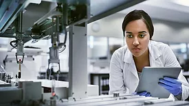 This image shows a person working in a laboratory setting with specialized equipment. 