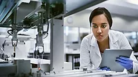 This image shows a person working in a laboratory setting with specialized equipment. 