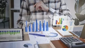 This image depicts a business professional analyzing financial data 