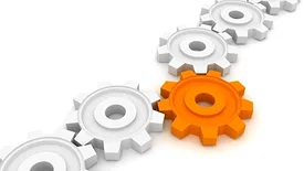 This image is a stock illustration depicting interconnected white gears with one prominent orange gear in the center. 