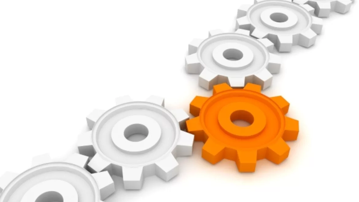 This image is a stock illustration depicting interconnected white gears with one prominent orange gear in the center.