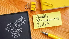The image highlights the concept of a Quality Management System (QMS). 