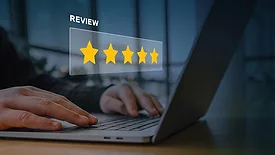 This image represents the concept of online customer feedback and reputation management, featuring a digital overlay of a five-star rating. 