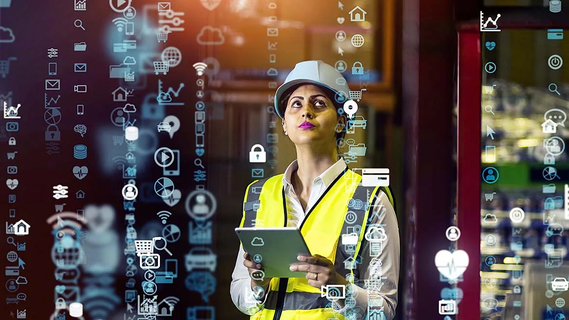 This image depicts a logistics manager using a tablet to monitor an automated supply chain system.