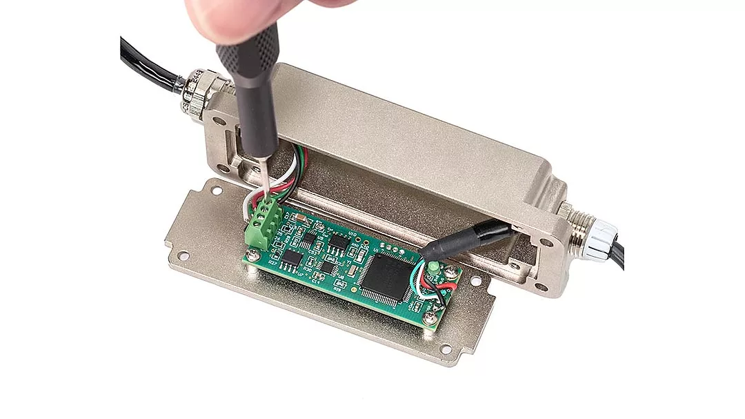 Connecting the leads from a force or torque sensor to an integrated digital interface.