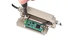 Connecting the leads from a force or torque sensor to an integrated digital interface.