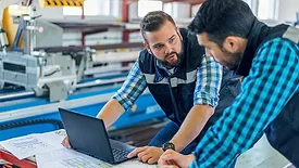 a moment of collaboration between two technicians