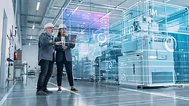 The image depicts a concept of industrial digitalization or a "digital twin" in a manufacturing environment