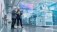 The image depicts a concept of industrial digitalization or a "digital twin" in a manufacturing environment