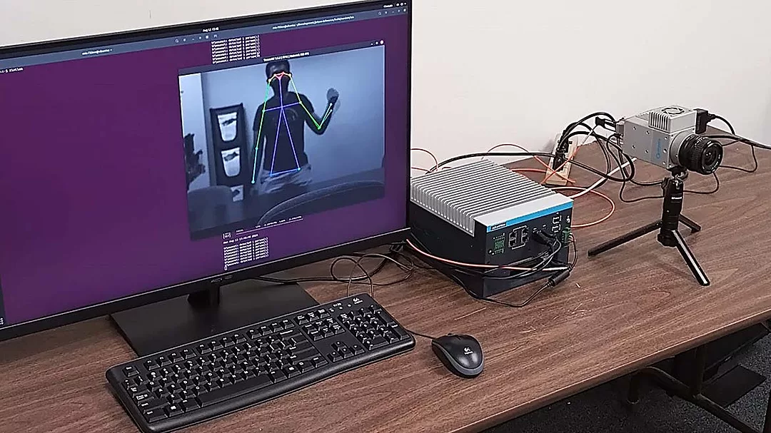 This image displays a high-speed machine vision system used for real-time human pose estimation.