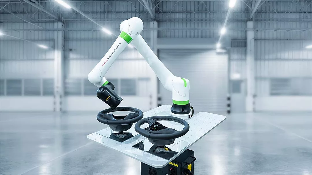 This is a FANUC CRX collaborative robot featuring a lightweight white design with bright green accents.