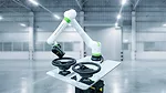 This is a FANUC CRX collaborative robot featuring a lightweight white design with bright green accents.