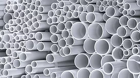 stacked white plastic pipes