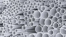 stacked white plastic pipes