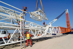 men working large metal crane
