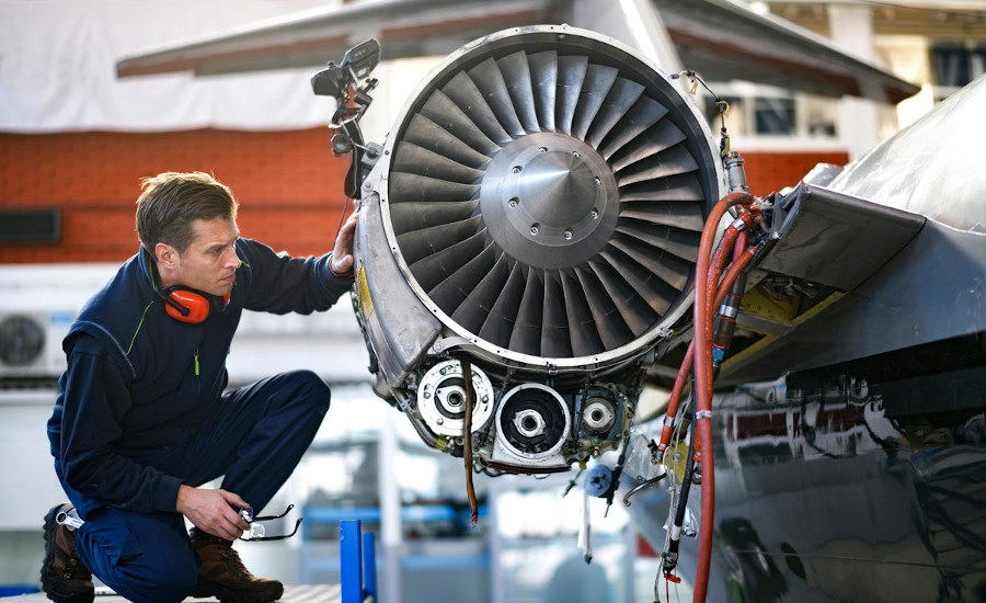 Man inspecting jet engine
